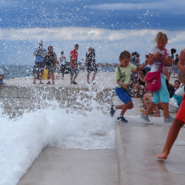 Children playfully splash on the edge of the sea