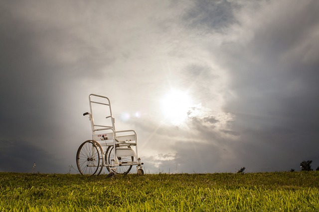 An empty wheelchair set against an omnious sky