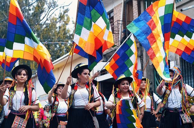 Bolivian woman parade with colourful flags