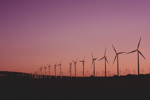 A row of wind turbines at dusk