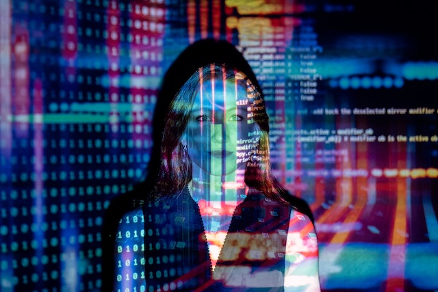 Woman illuminated by streams of data