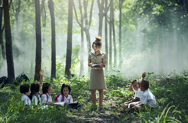 A teacher lectures to students outside.