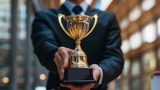 A man presents a golden award trophy