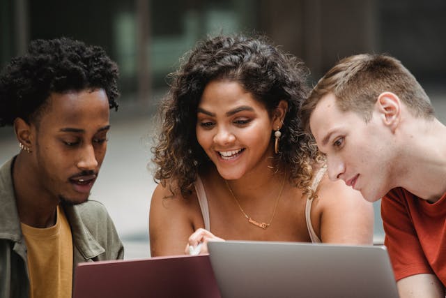 A trio of young academics discuss a research question.