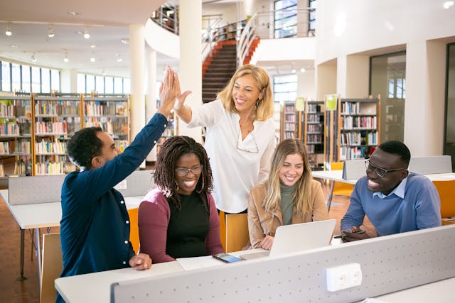 A group of young researchers in a research library