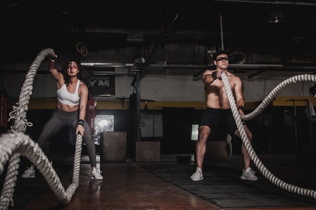 Two people working out with long ropes