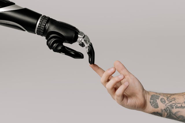 Robotic hand touches a human hand