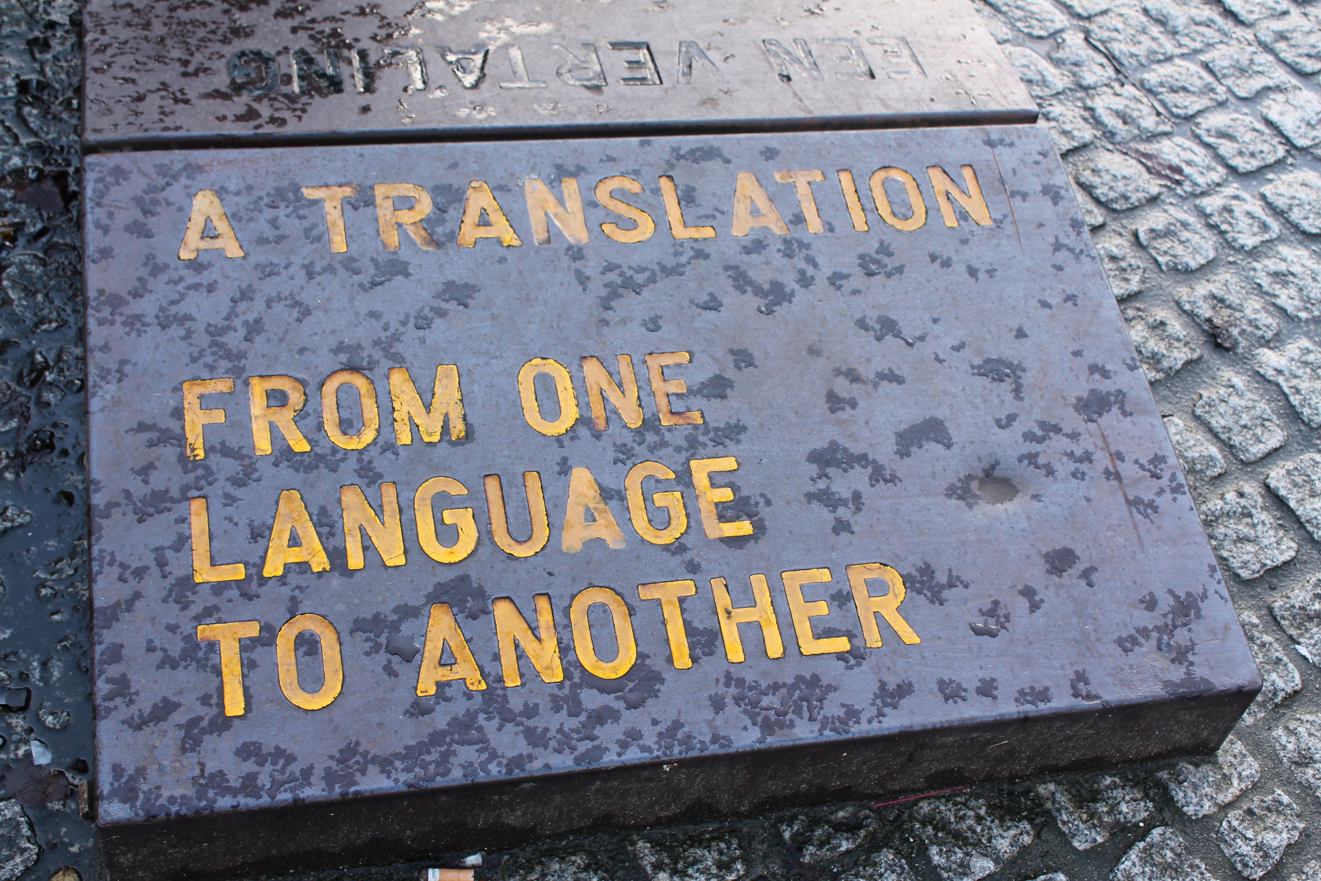 An image of the words 'A Translation of One Language to Another' inscribed in stone