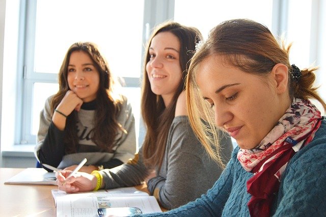 Three women studying in a classroom